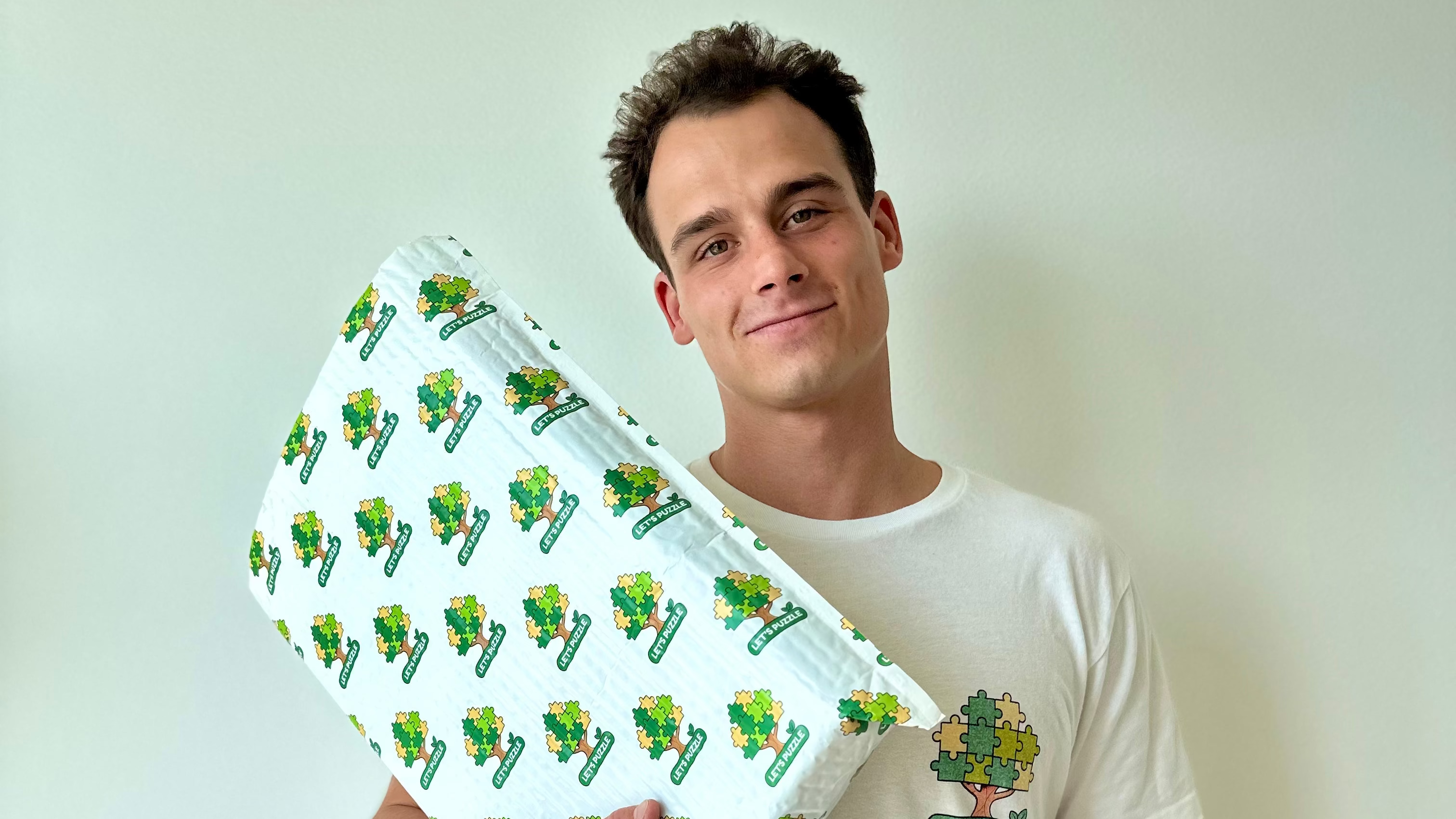 Man holding a bubble wrap against a plain background