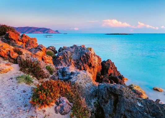 Ravensburger 1000 piece Rocky coastline with turquoise water and distant island.